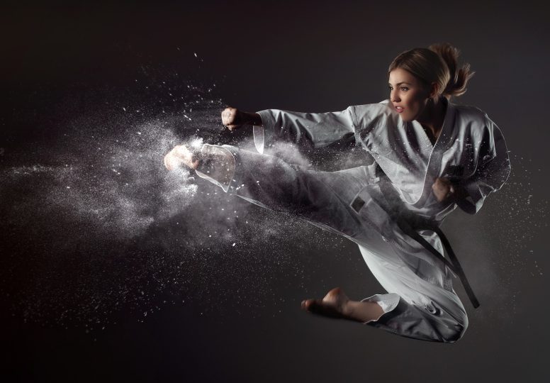 Karate girl bounces and makes a kick